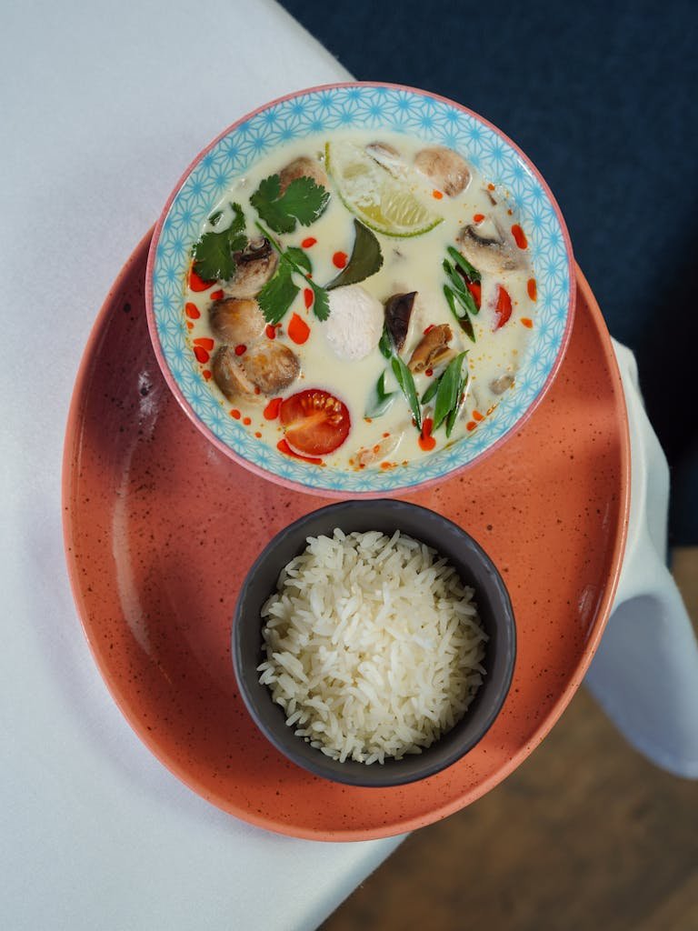 A delicious bowl of Thai curry served with a side of rice, artfully presented. Made from one of my favourite Thai curry recipes.