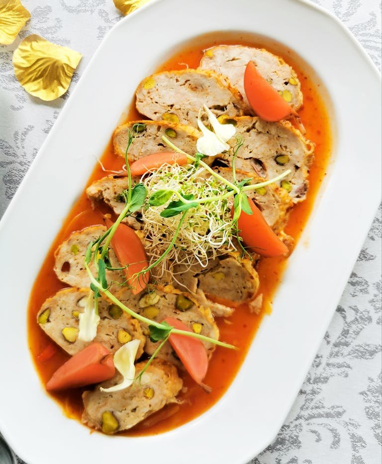 Meatloaf Pieces in Tomato Sauce on White Plate