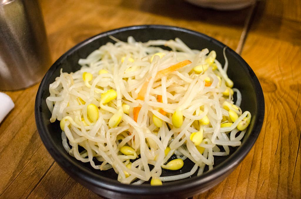Delicious Korean bean sprouts served as a healthy side dish in a black bowl.