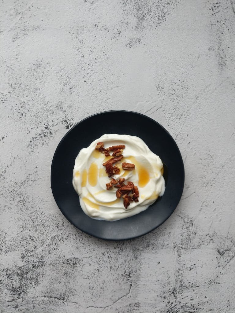 A mouthwatering plate of Greek yogurt sauces topped with pecans and drizzled with honey.