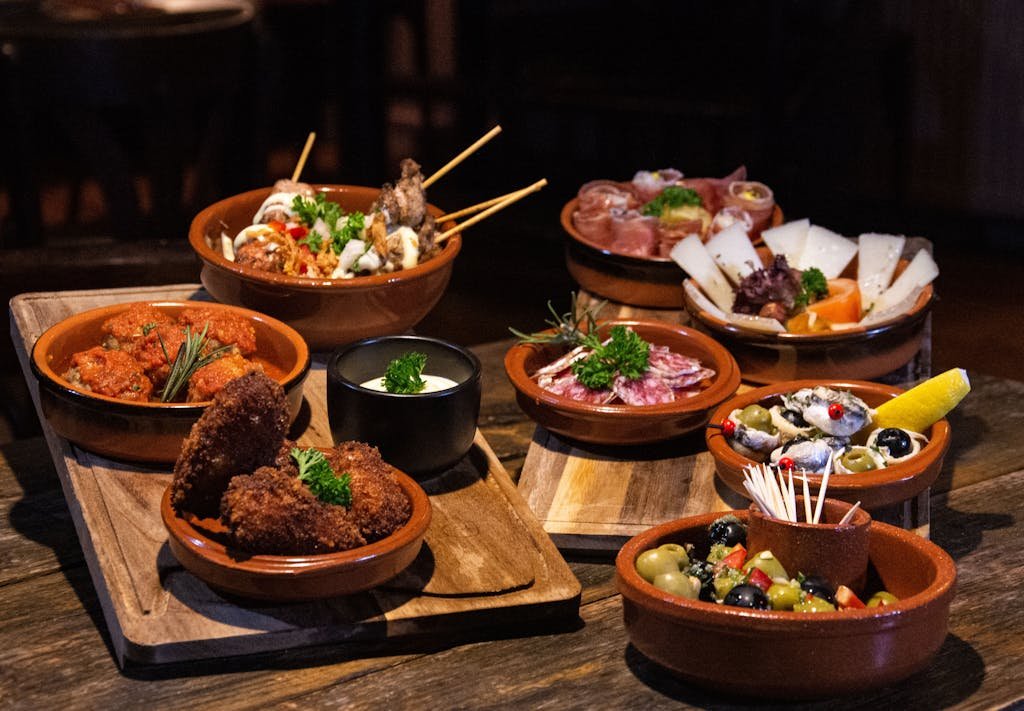 Spanish tapas dishes served in rustic style on a wooden table using my Spanish tapas recipes