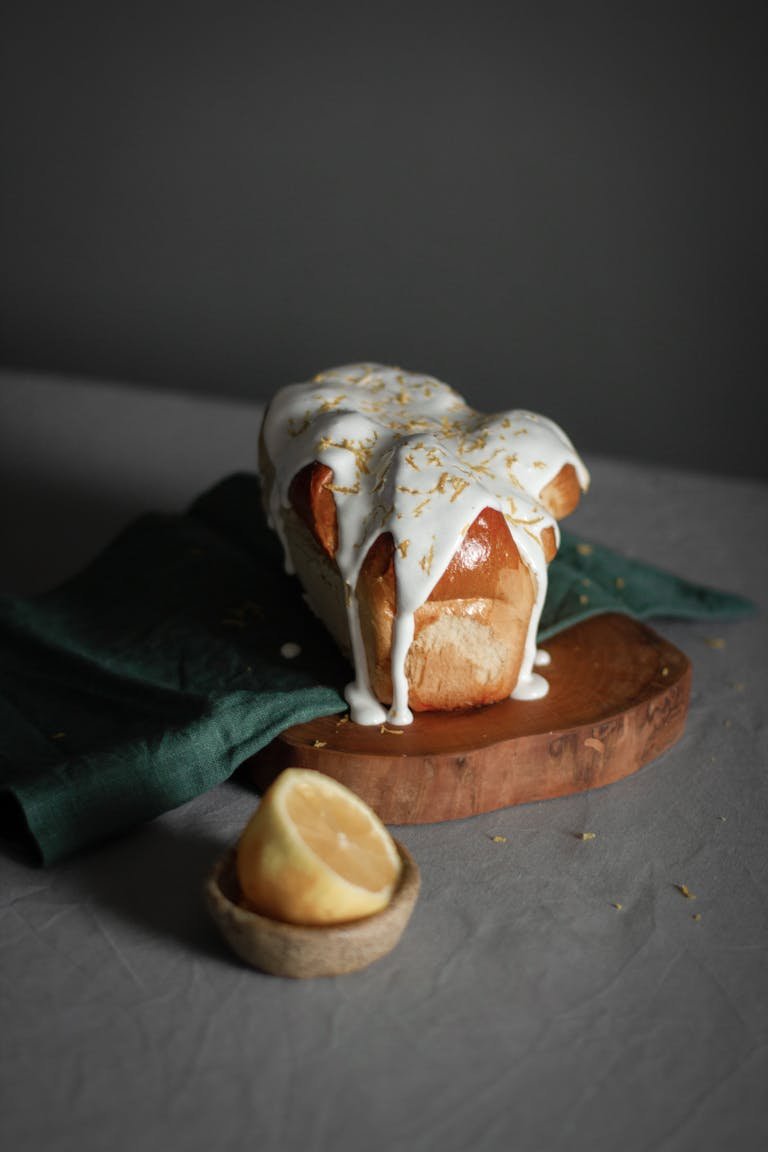 Close-up of a lemon drizzle cake on a board, perfect for gourmet food presentations.