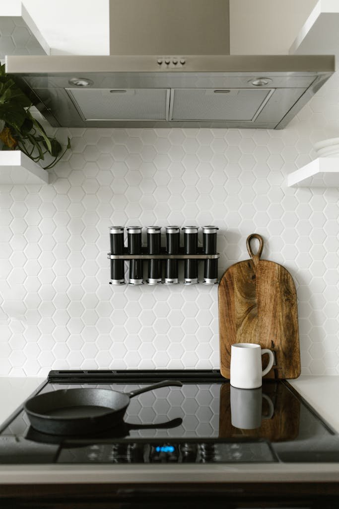 kitchen featuring an induction stove, spice rack, and wooden chopping board.