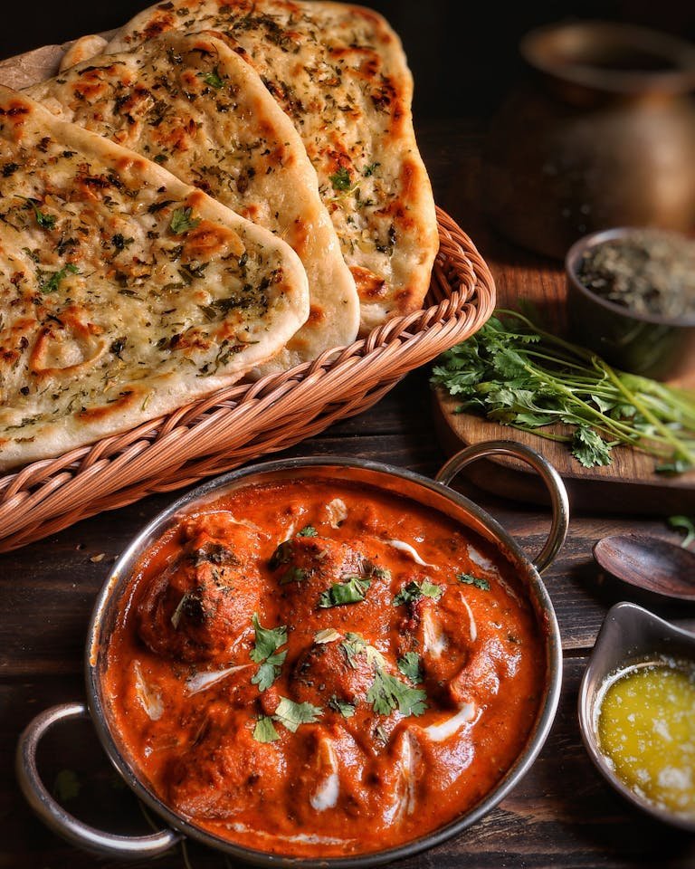 Close-up of flavorful easy butter chicken recipe with garlic naan, capturing the essence of Indian cuisine.