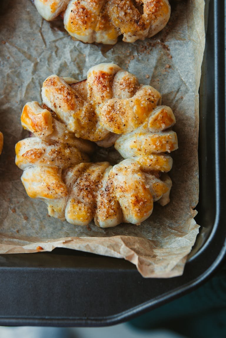 Freshly baked cinnamon Danish pastry on parchment showcasing one of the best sheet pan sets.