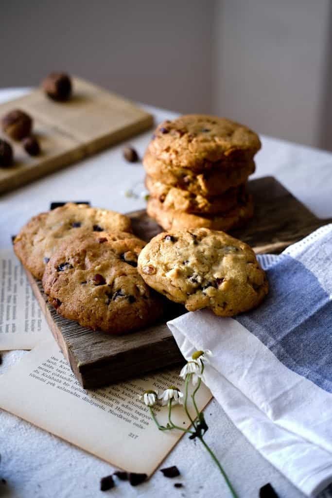 Rustic arrangement of homemade brown butter chocolate chip cookies on wooden boards.