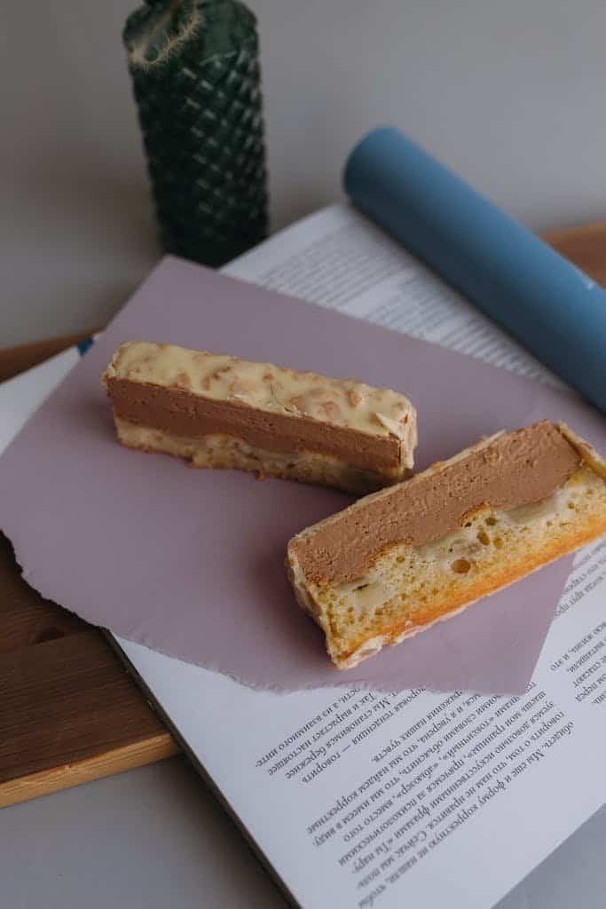 A peanut and chocolate dessert bar placed on paper, perfect for indulgence.