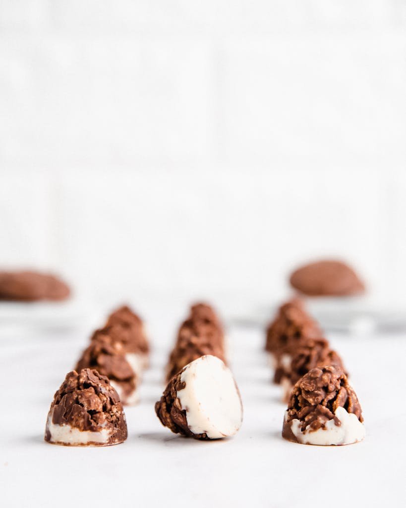 Close-up of chocolate puffed rice snacks on white background, perfect for dessert lovers.