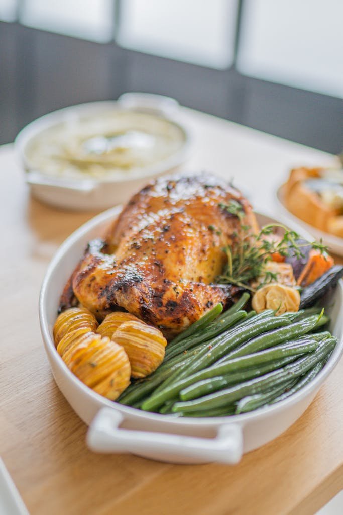 A savory roast chicken with green beans and potatoes, perfect for a family meal.