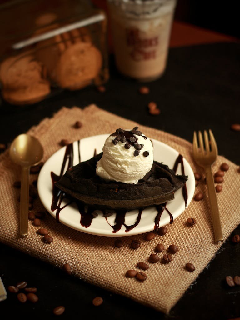 Luxurious chocolate waffle dessert topped with ice cream and chocolate chips for an indulgent treat.